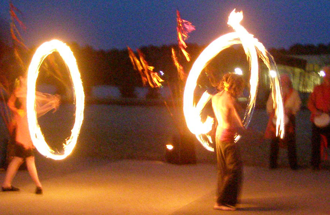 A photo of fire twirlers